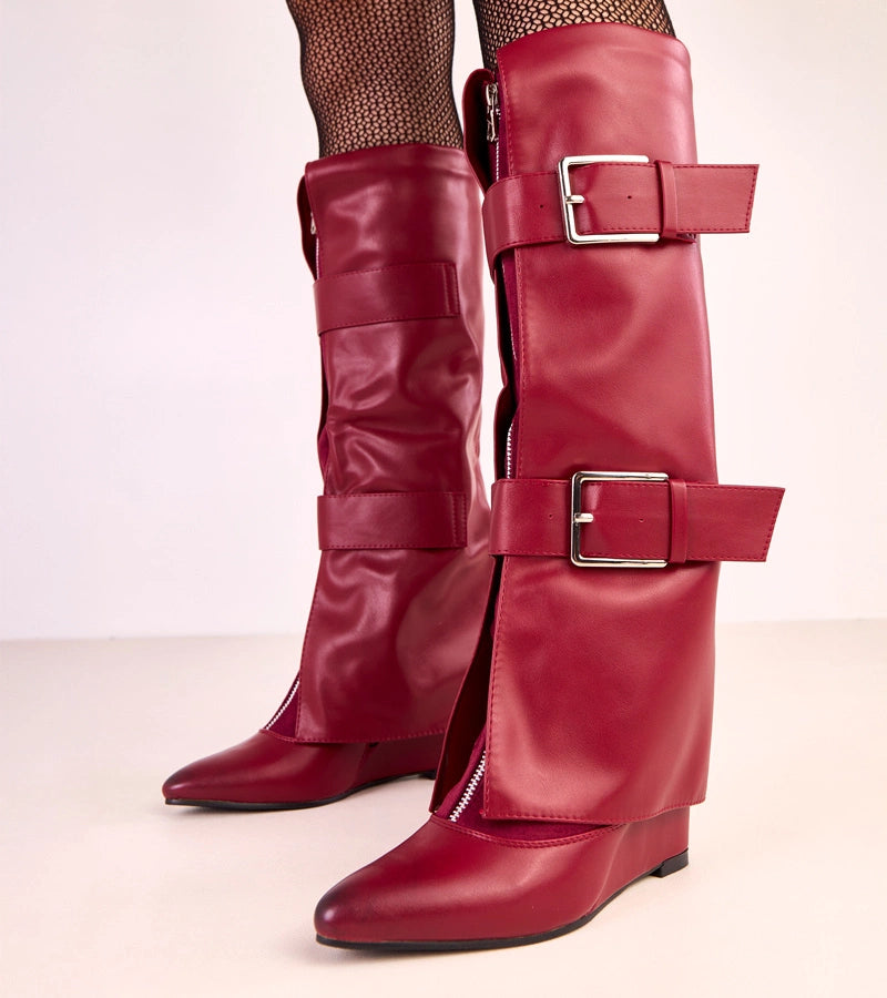 Red wedge boots with decorative buckles by Toadera