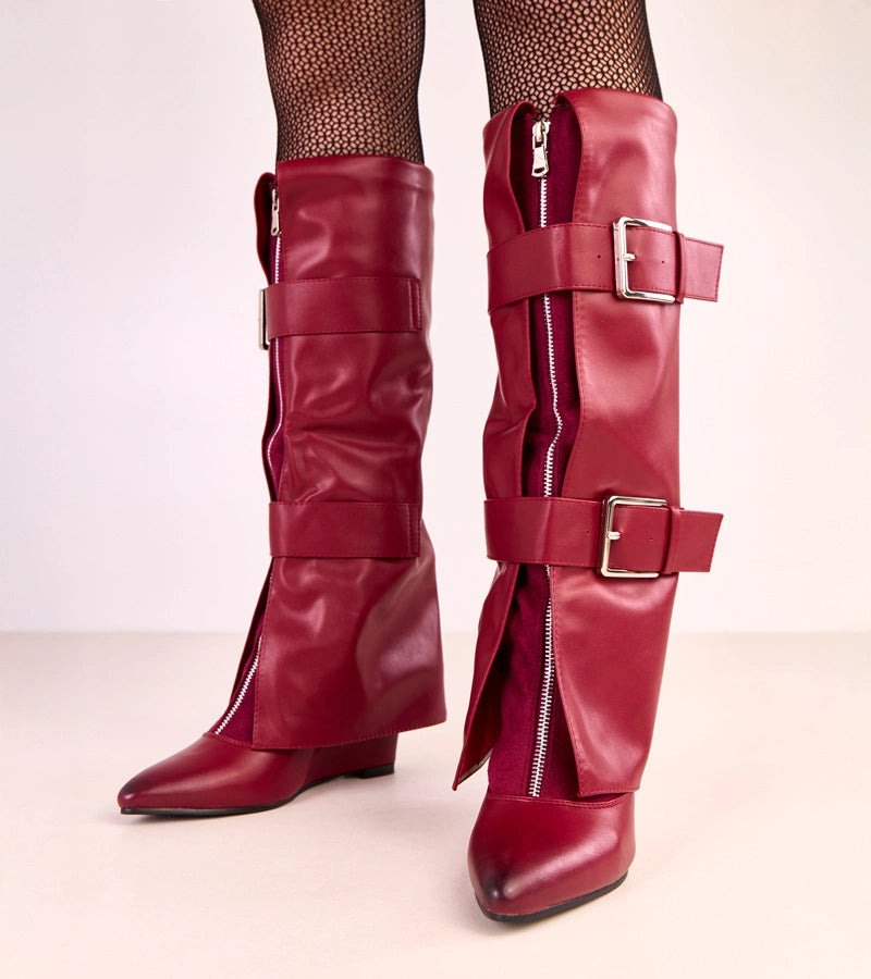 Red wedge boots with decorative buckles by Toadera