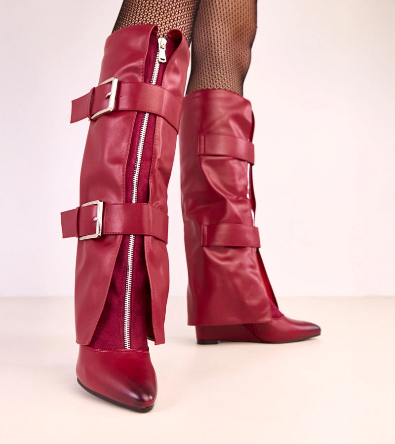 Red wedge boots with decorative buckles by Toadera